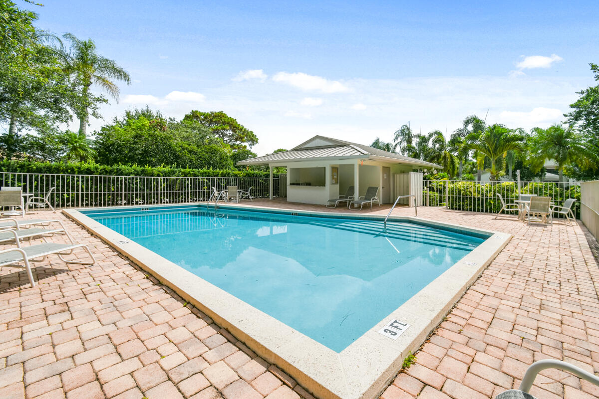 13312 Northwest Maplewood Road Palm City, FL 34990 - Photo 52 of 69 a view of a swimming pool with a patio