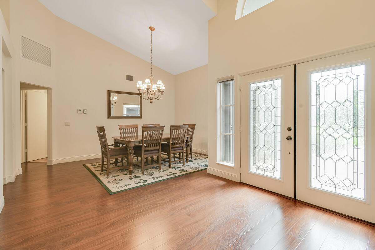 13312 Northwest Maplewood Road Palm City, FL 34990 - Photo 10 of 69 a view of a dining room with furniture window and wooden floor