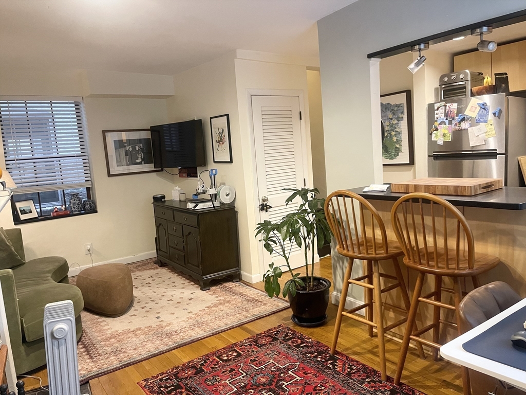 9 Primus Avenue, Unit 1 Boston, MA 02114 - Photo 2 of 19 a bedroom with a bed and flat screen tv