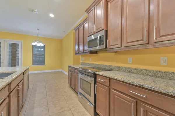a kitchen with stainless steel appliances granite countertop a sink and a granite counter tops