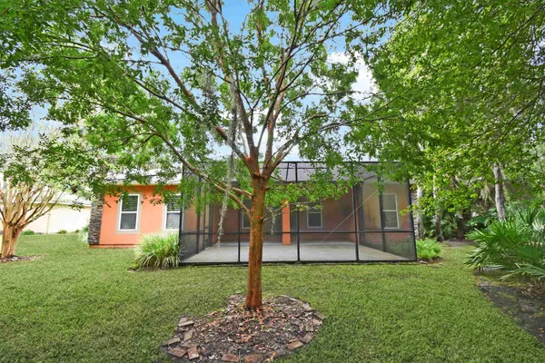a view of a house with a backyard