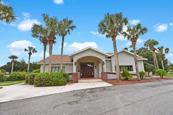a view of a house with a yard and a garden