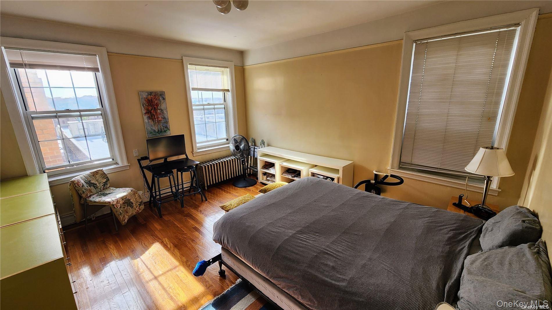 4 Maple Drive, Unit 6H Great Neck, NY 11021 - Photo 11 of 14 a bedroom with furniture and a window