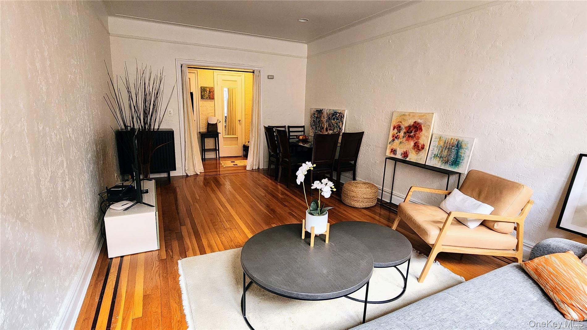 4 Maple Drive, Unit 6H Great Neck, NY 11021 - Photo 4 of 14 a living room with furniture and a fireplace