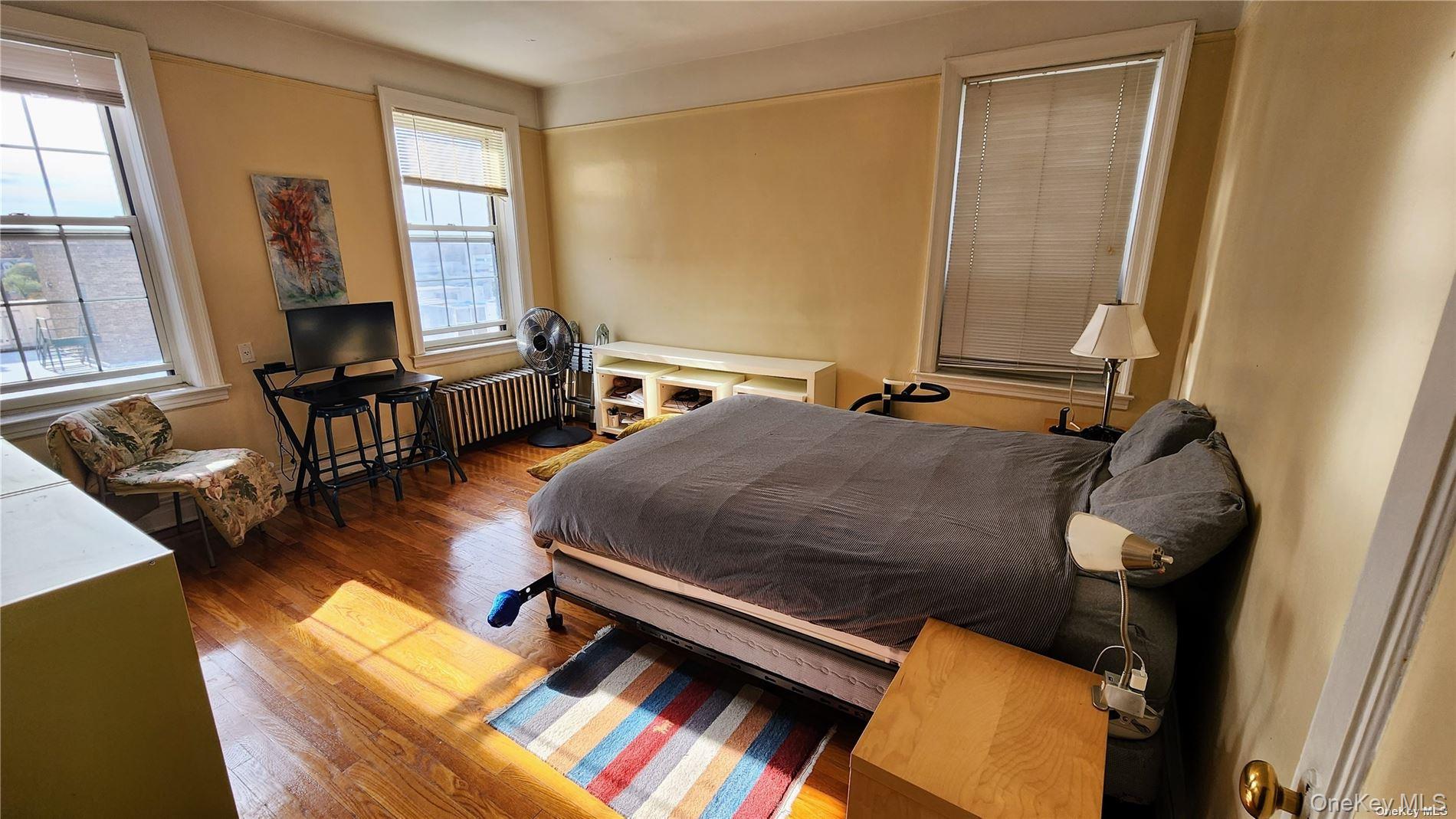 4 Maple Drive, Unit 6H Great Neck, NY 11021 - Photo 10 of 14 a bedroom with furniture and a window