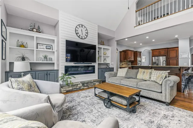 a bedroom with a bed and a dresser next to a window