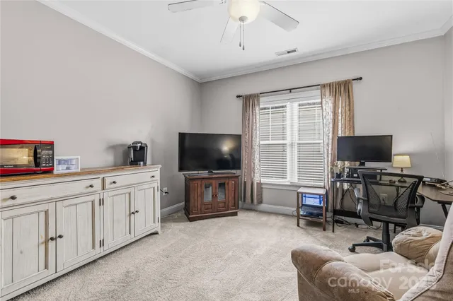 a spacious bedroom with a bed and a chandelier
