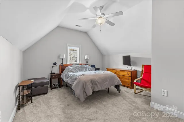 a bathroom with a granite countertop sink a toilet a mirror and shower