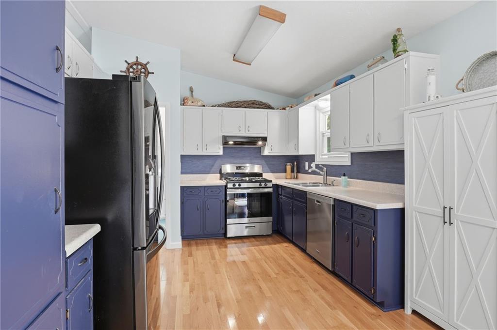 338 Arbour Way Suwanee, GA 30024 - Photo 7 of 32 a kitchen with stainless steel appliances granite countertop a refrigerator stove and sink