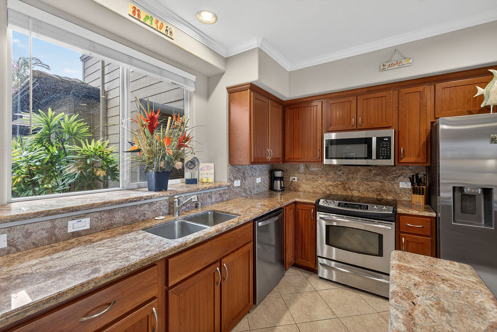 68-1122 Na Ala Hele Road, Unit H2 Kamuela, HI 96743 - Photo 4 of 12 a kitchen with stainless steel appliances granite countertop a sink and a microwave