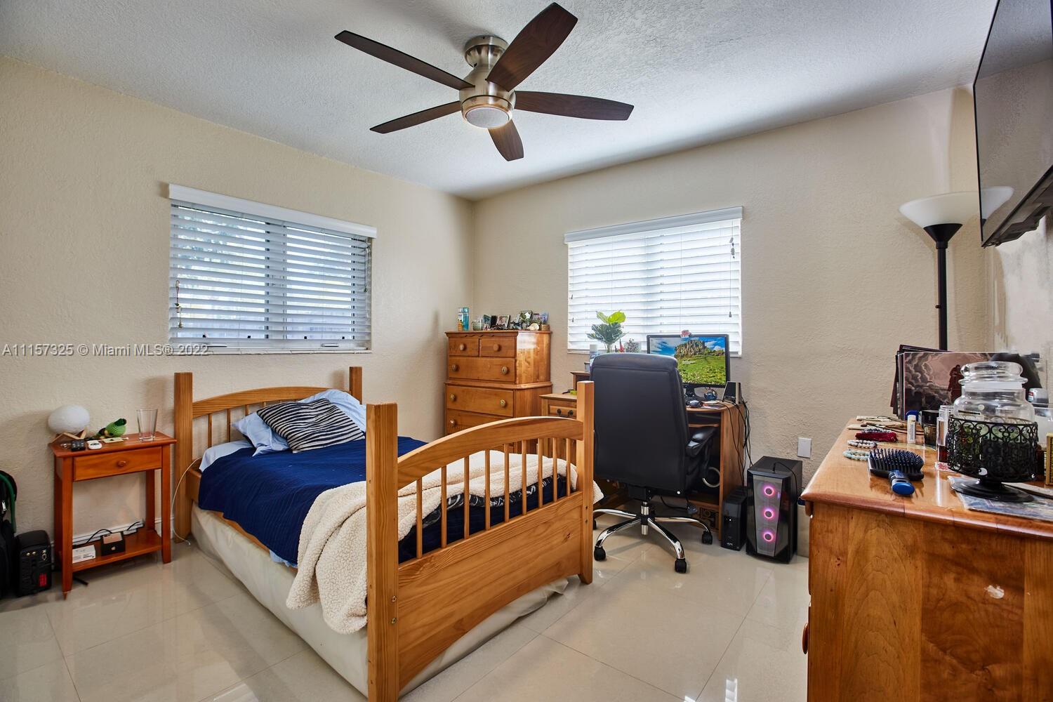 11103 Southwest 124th Road Miami, FL 33176 - Photo 16 of 23 a bedroom with furniture and a window
