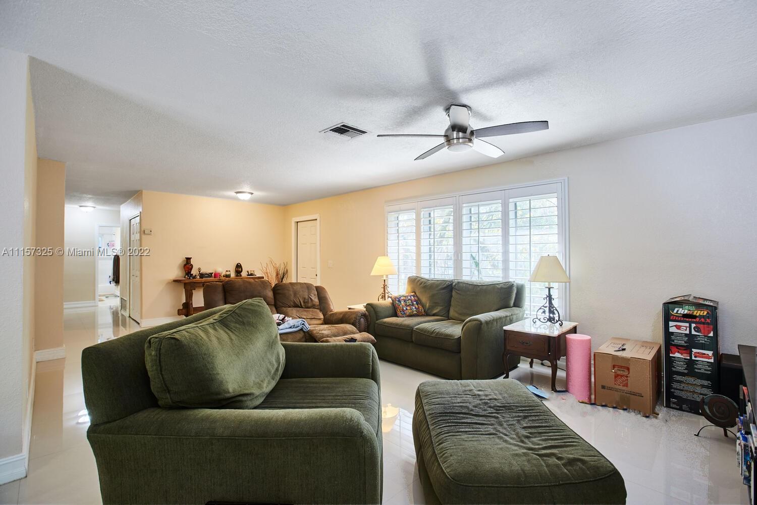 11103 Southwest 124th Road Miami, FL 33176 - Photo 5 of 23 a living room with furniture ceiling fan and a window
