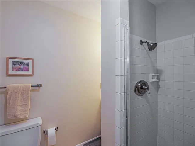 a bathroom with a shower a toilet and a sink