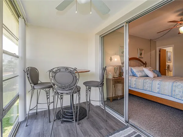 a view of a room with furniture and wooden floor