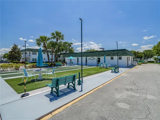 a view of a building with a swimming pool and a yard
