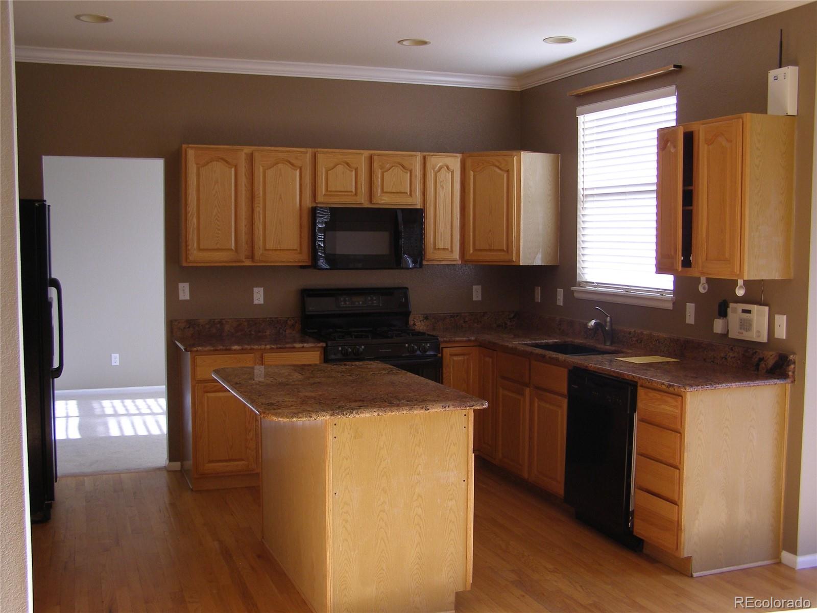 1730 Spring Water Place Highlands Ranch, CO 80129 - Photo 5 of 31 a kitchen with a sink a stove and cabinets