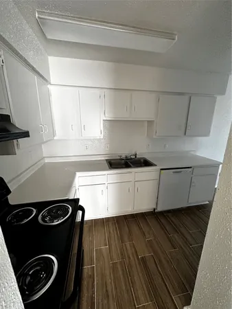 a kitchen with a stove and a refrigerator