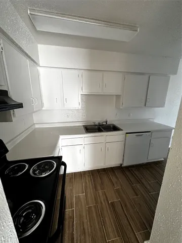 a kitchen with a stove and a refrigerator