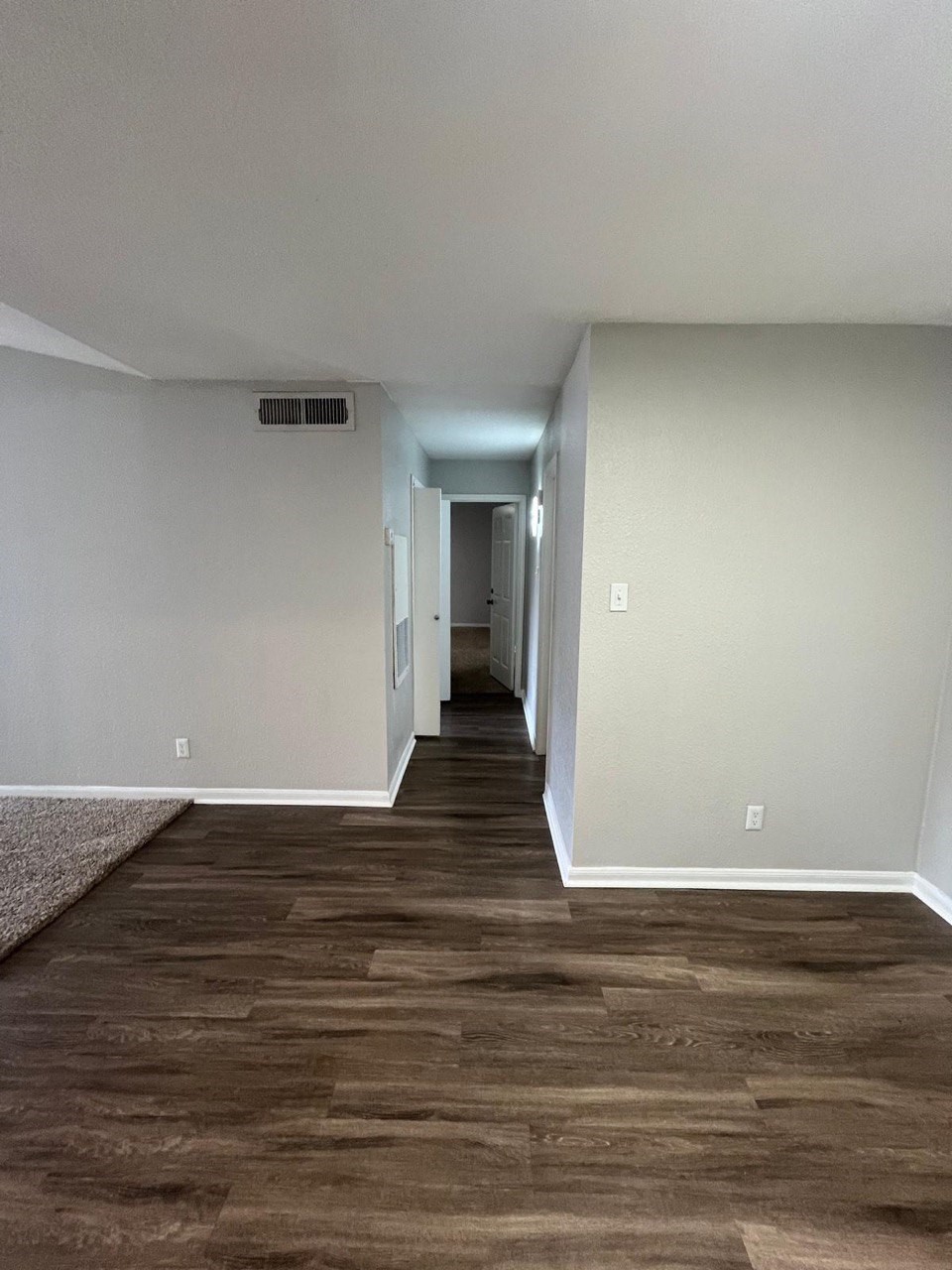 a view of a room with wooden floor