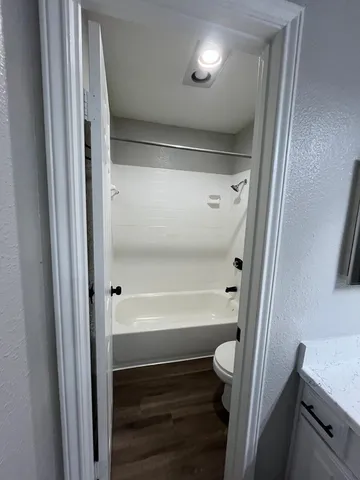 a bathroom with a bathtub and a shower