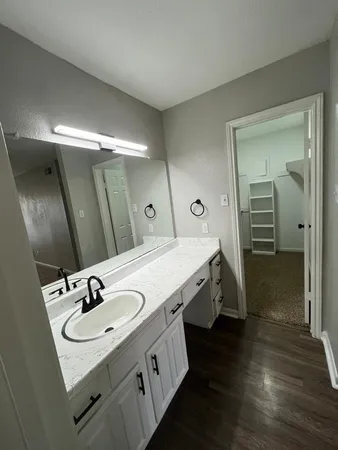 a bathroom with a double vanity sink and a mirror