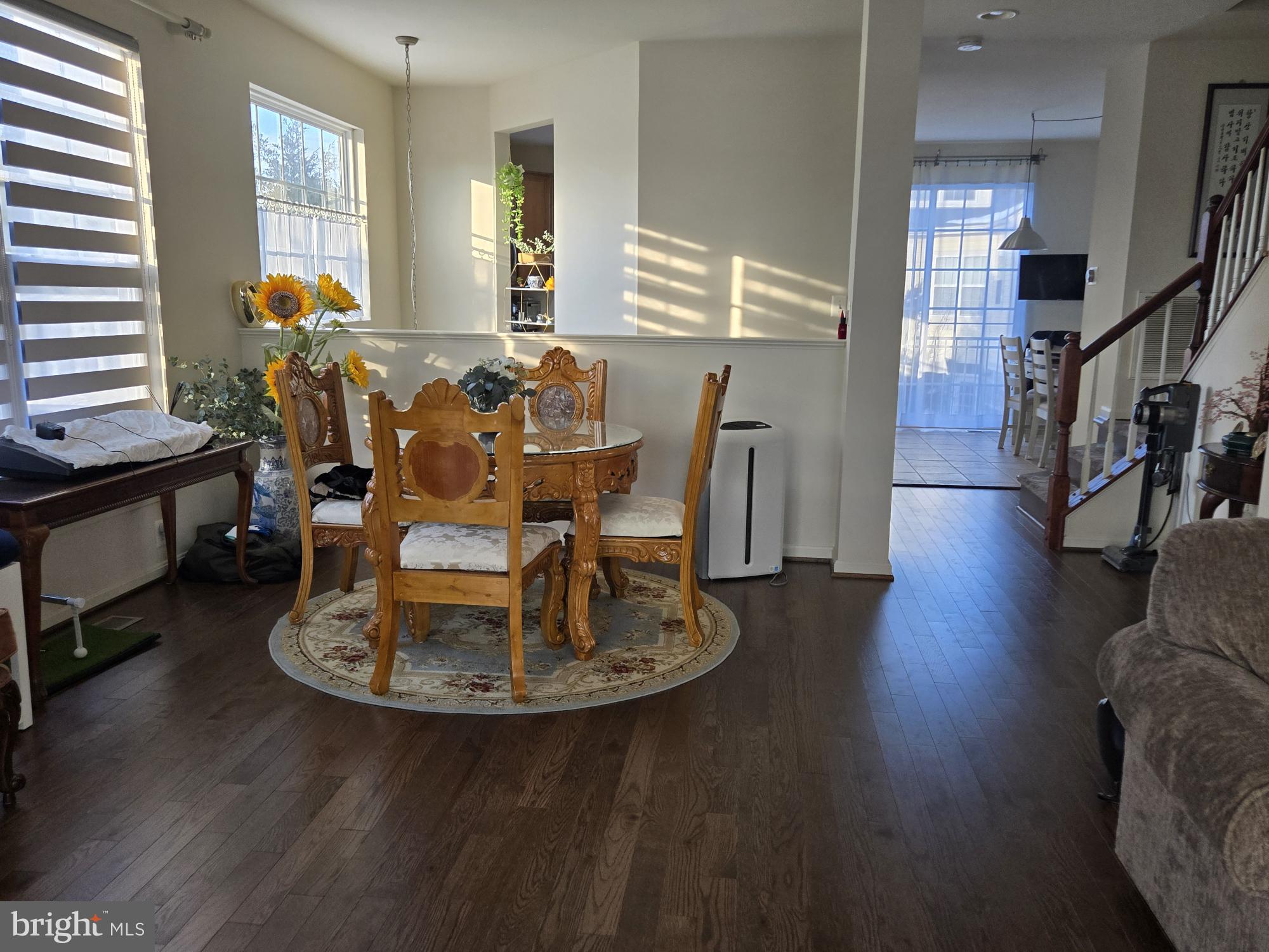 9254 Cascade Falls Drive Bristow, VA 20136 - Photo 11 of 14 a dining room with wooden floor and large windows