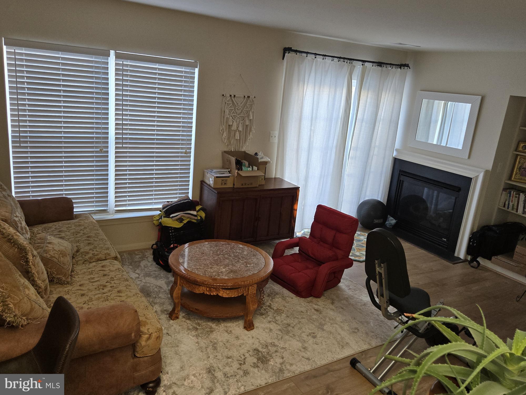 9254 Cascade Falls Drive Bristow, VA 20136 - Photo 12 of 14 a living room with furniture a window and a fireplace