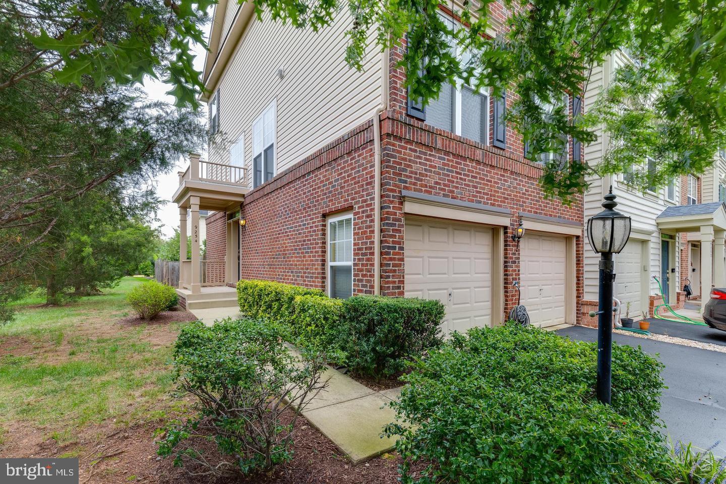 9254 Cascade Falls Drive Bristow, VA 20136 - Photo 4 of 14 a front view of a house with garden