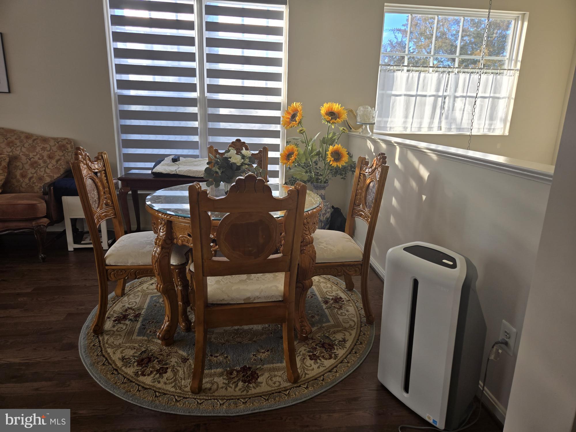 9254 Cascade Falls Drive Bristow, VA 20136 - Photo 6 of 14 a view of a dining room with furniture and wooden floor