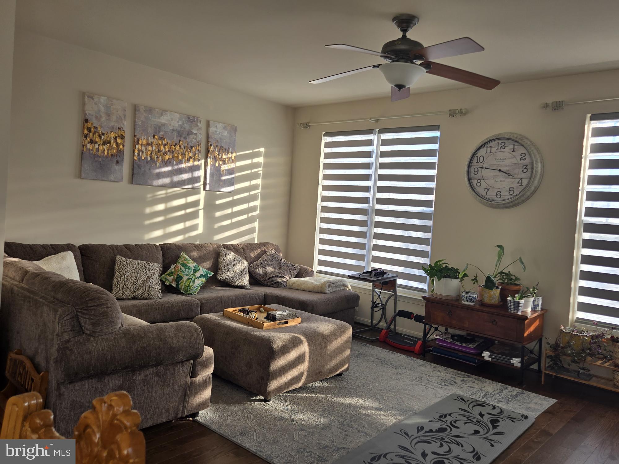 9254 Cascade Falls Drive Bristow, VA 20136 - Photo 8 of 14 a living room with furniture a window and a clock