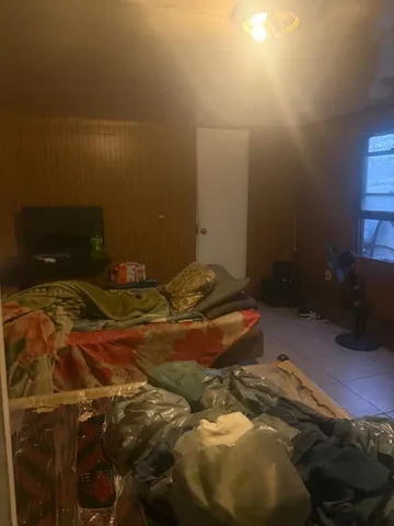 a bedroom with a bed and a fireplace