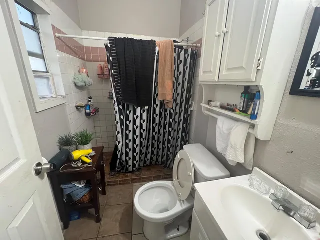 a bathroom with a sink toilet and shower