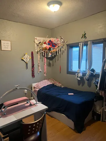 a bedroom with a bed and a table