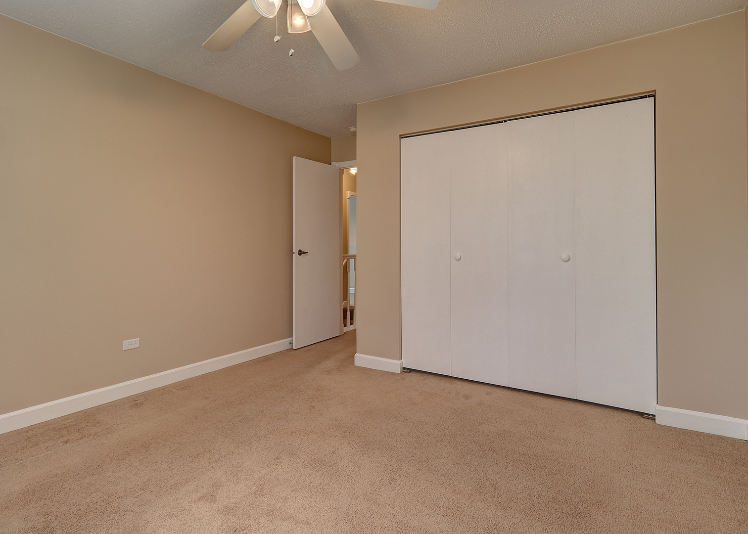 14803 South Penn Road Plainfield, IL 60544 - Photo 12 of 17 an empty room with a ceiling fan and closet area