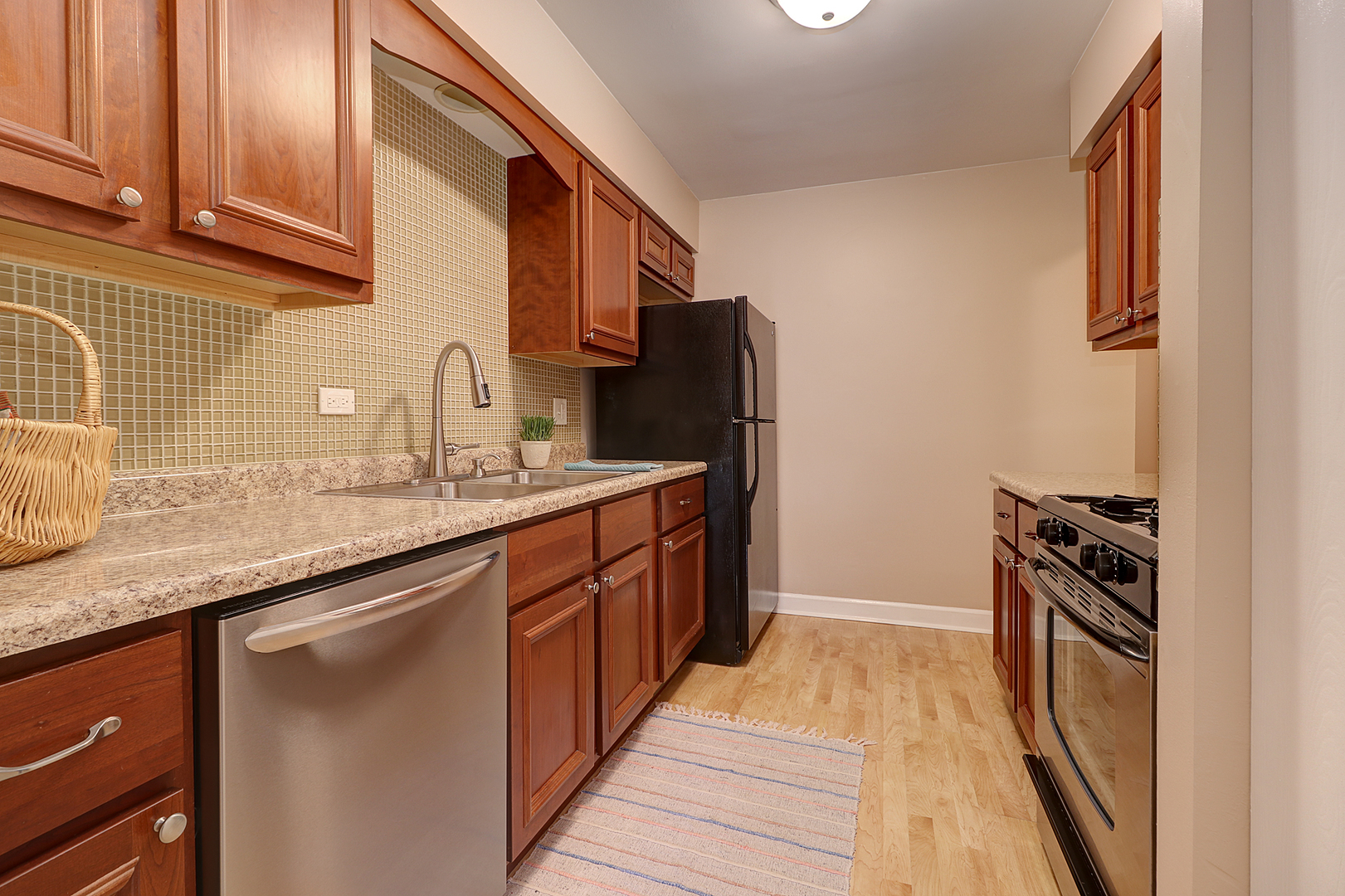 14803 South Penn Road Plainfield, IL 60544 - Photo 7 of 17 a kitchen with stainless steel appliances granite countertop a sink stove and refrigerator