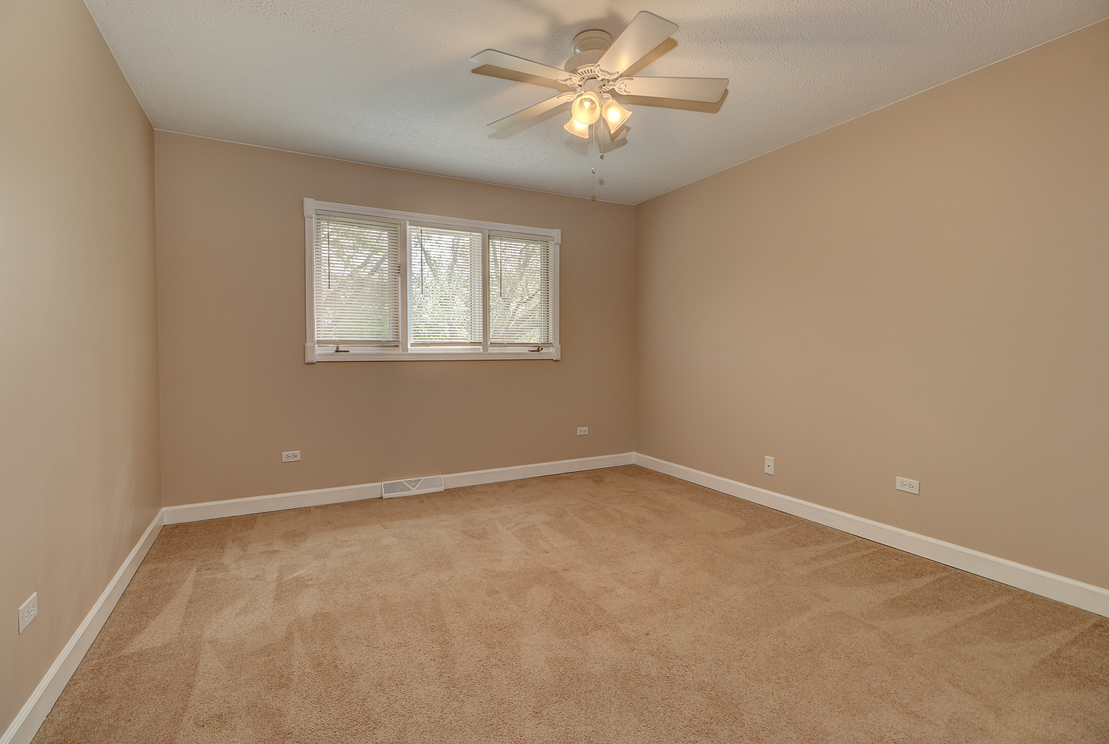 14803 South Penn Road Plainfield, IL 60544 - Photo 10 of 17 an empty room with a window and a fan