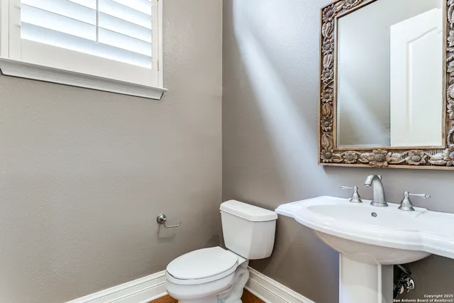 a bathroom with a granite countertop sink mirror and bathtub