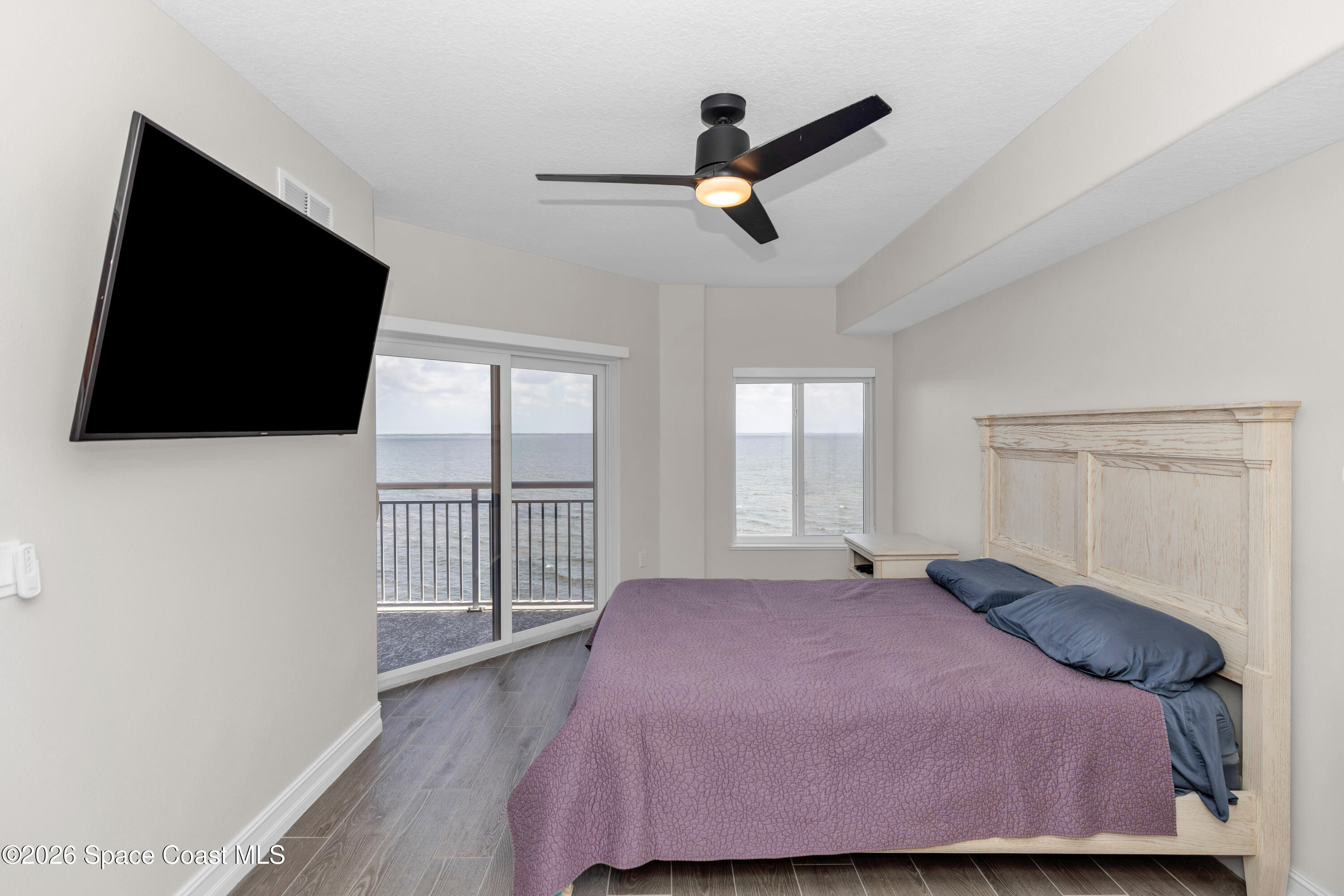 1805 Riverside Drive, Unit 506 Titusville, FL 32780 - Photo 12 of 24 a bedroom with a bed and a flat screen tv