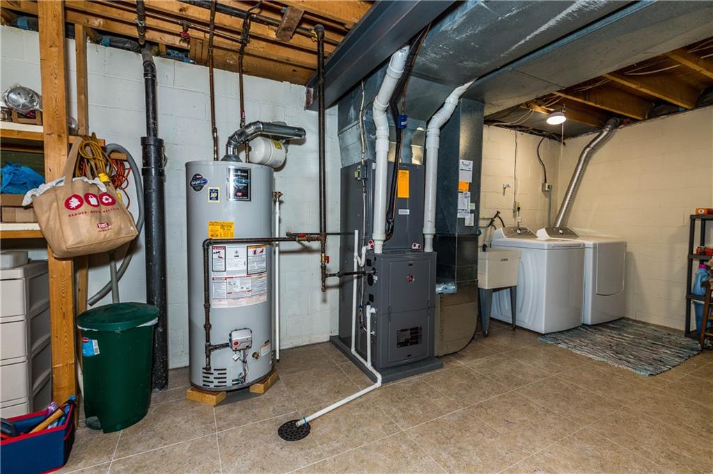 230 Ridgeview Drive Wexford, PA 15090 - Photo 21 of 25 Basement unfinished area , but has tile flooring....AC/ Furnace/ Hot Water Tank 2016 . Current Owners moved the Laundry area from upstairs Mud Room off the Kitchen to the basement.(can easily be converted back to main level ). There is also a ton of storage area in this room as well..