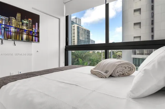 a bedroom with a bed and window