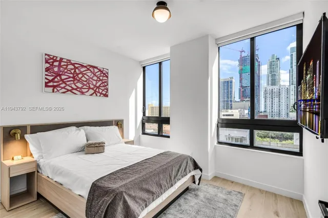 a bedroom with a bed and a window