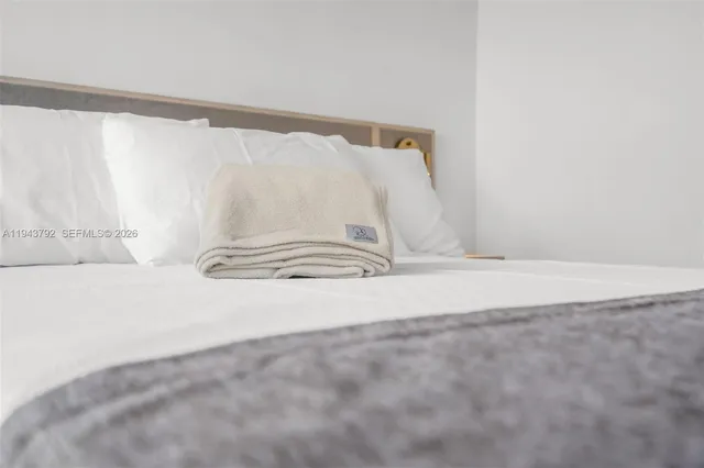 a view of a room with wooden floor and a window