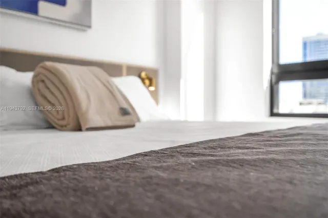 a bedroom with a bed and a book shelf