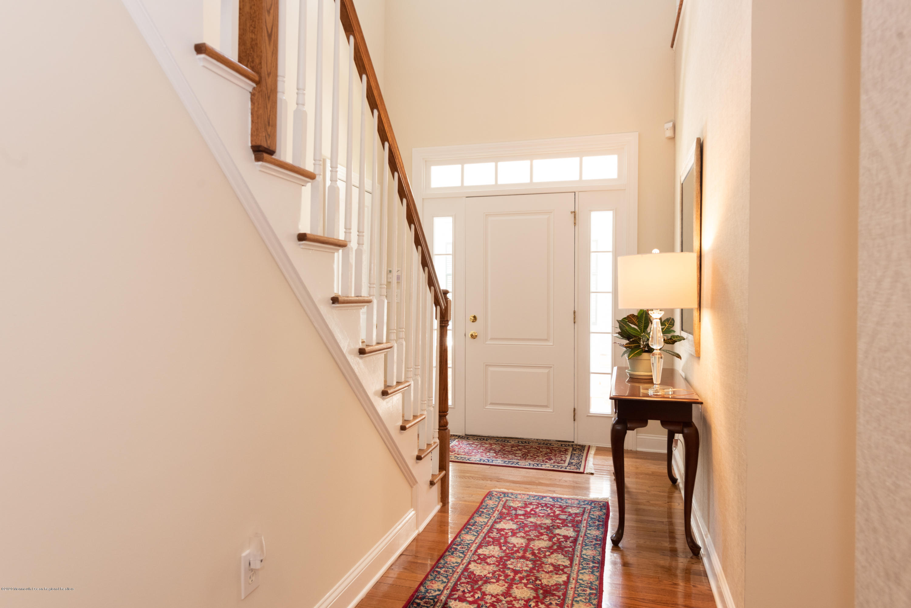 10 Adams Way Shrewsbury, NJ 07702 - Photo 2 of 19 a view of hallway with stairs and wooden floor