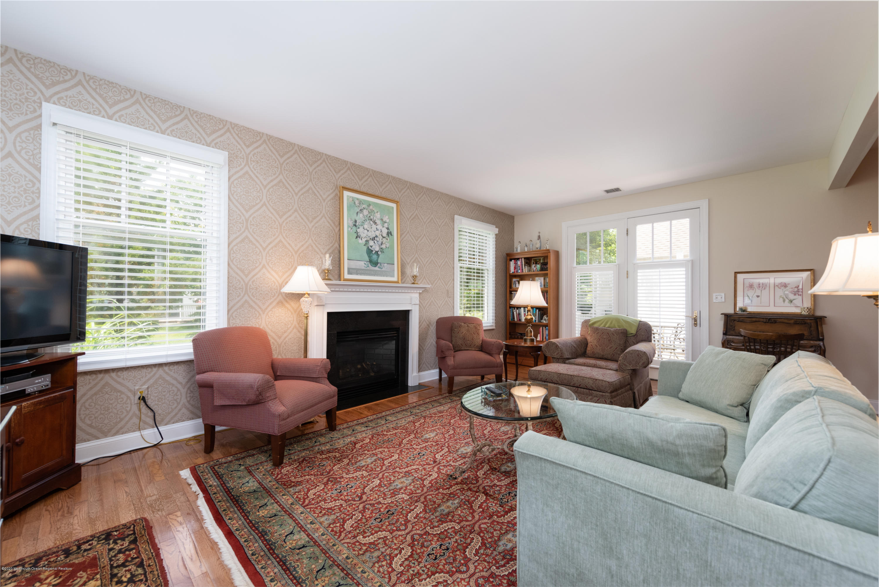 10 Adams Way Shrewsbury, NJ 07702 - Photo 6 of 19 a living room with furniture a fireplace and a flat screen tv