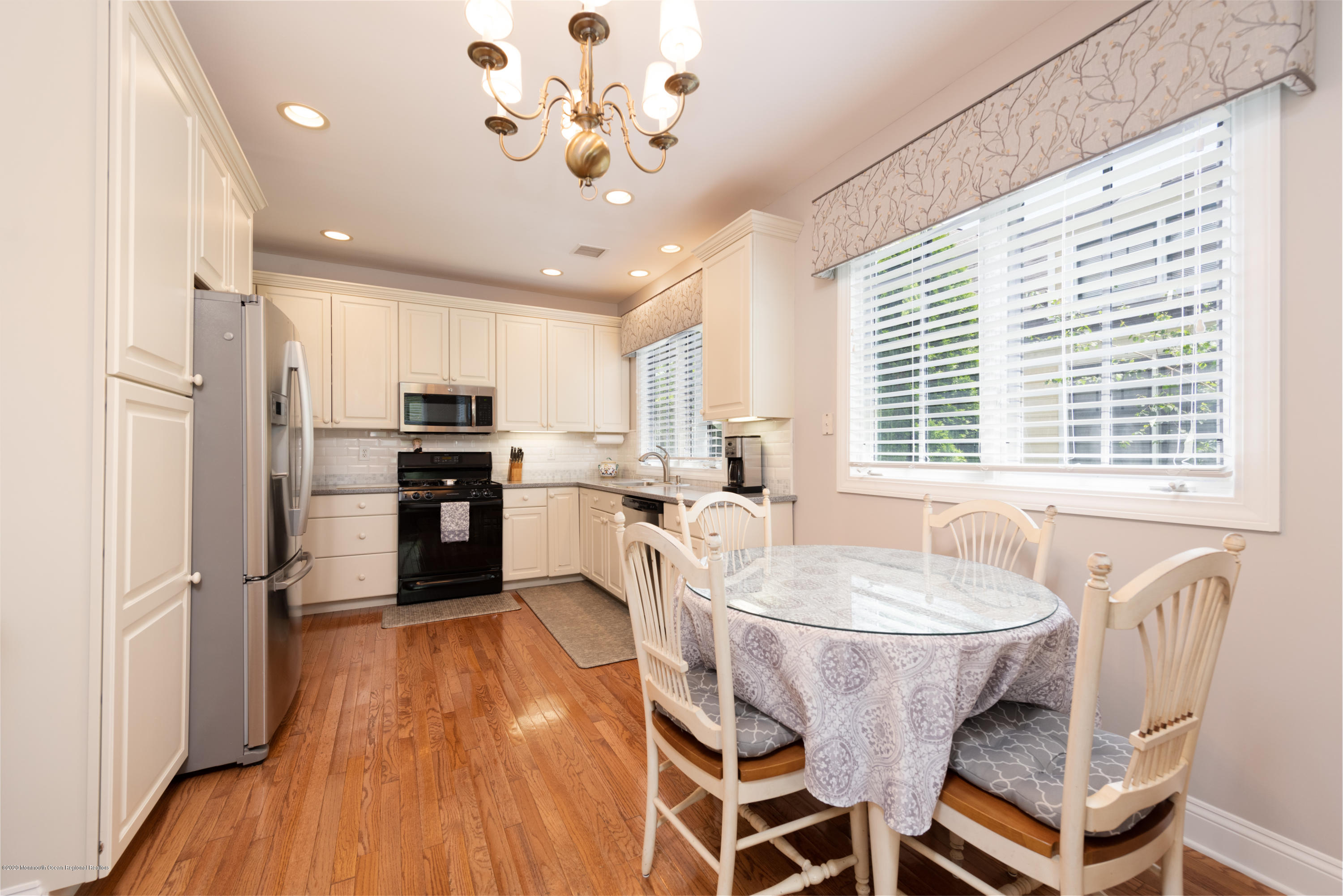 10 Adams Way Shrewsbury, NJ 07702 - Photo 7 of 19 a large kitchen with kitchen island a large counter space a sink appliances and cabinets