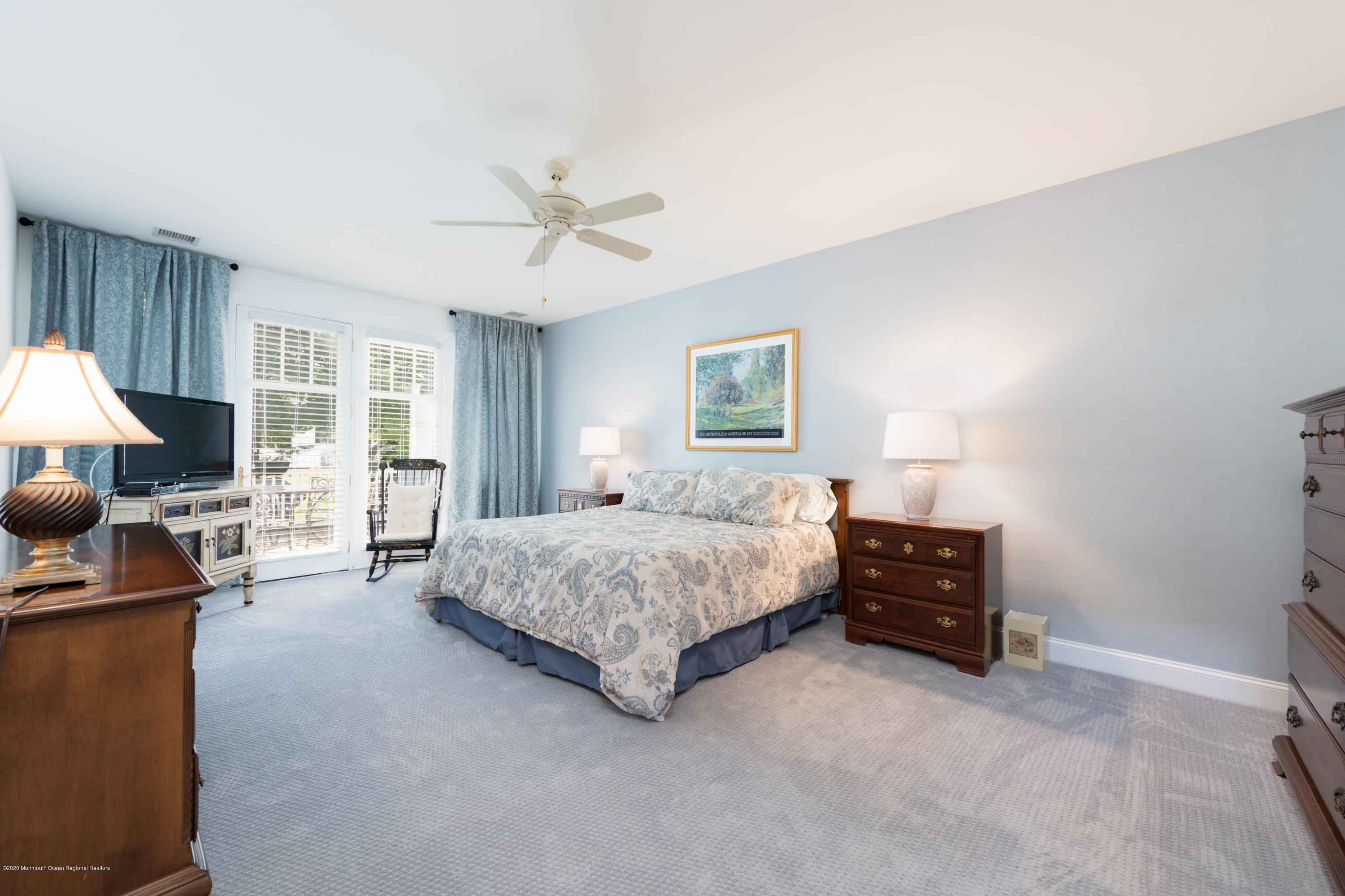 10 Adams Way Shrewsbury, NJ 07702 - Photo 10 of 19 a spacious bedroom with a bed a couch and a window