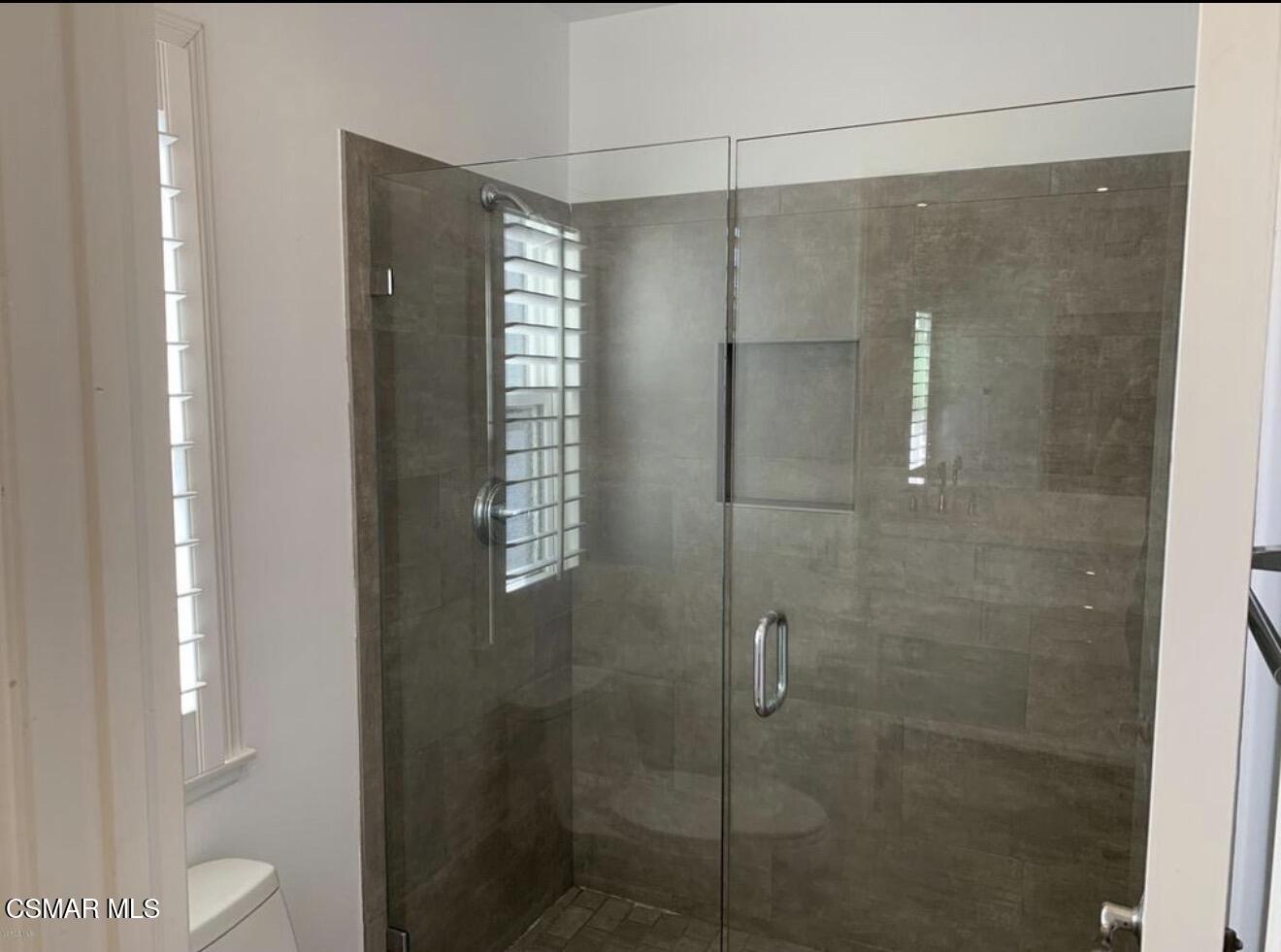924 Thistlegate Road Oak Park, CA 91377 - Photo 16 of 20 a bathroom with a shower and a toilet