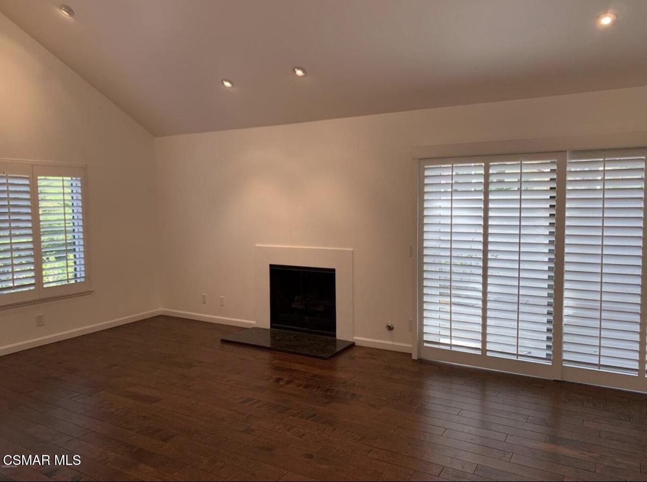 924 Thistlegate Road Oak Park, CA 91377 - Photo 4 of 20 an empty room with wooden floor and a window