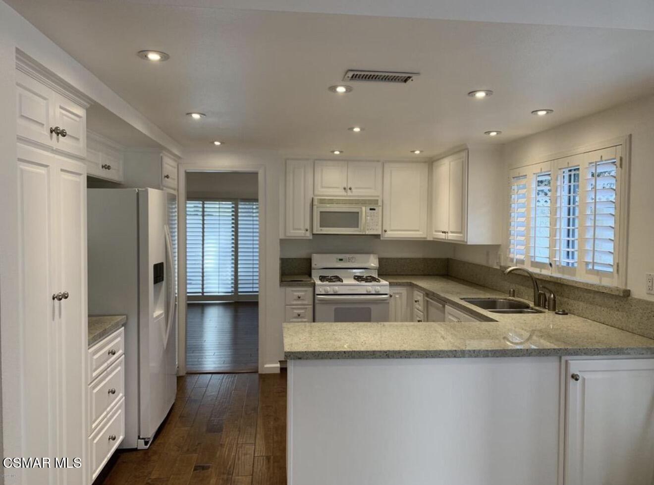 924 Thistlegate Road Oak Park, CA 91377 - Photo 5 of 20 a kitchen with stainless steel appliances granite countertop a sink stove and refrigerator